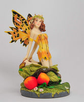 A Salons Gold Color Winged Fairy Sitting on Foliage Statue Figurine